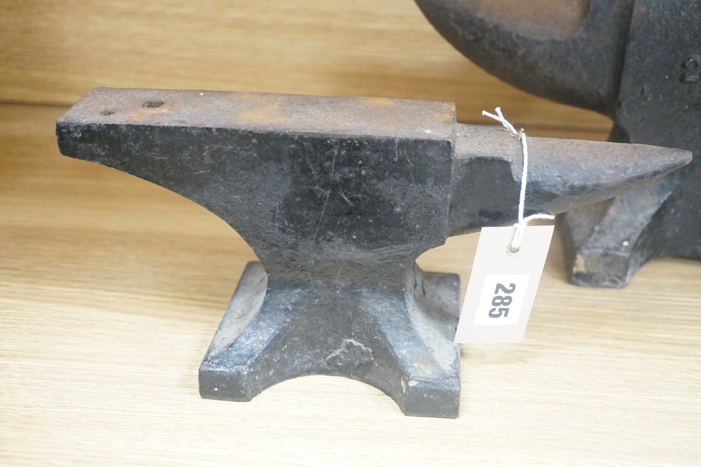 Two cast iron anvils, largest 32cm long and 28lbs
